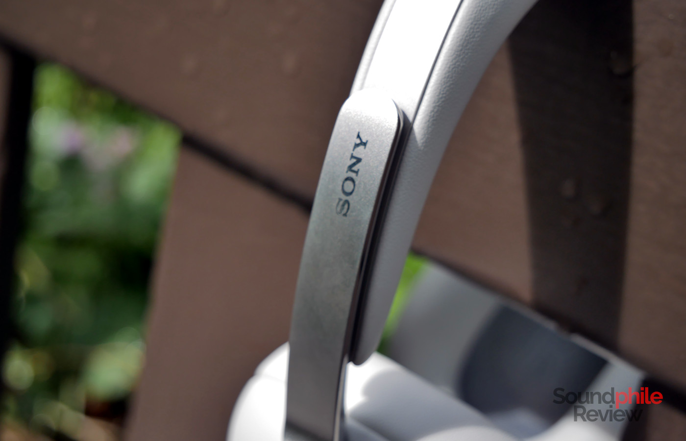 The Sony logo on the Sony 1000X THE COLLEXION headband stands out as it is glossy on a sanded/matte surface